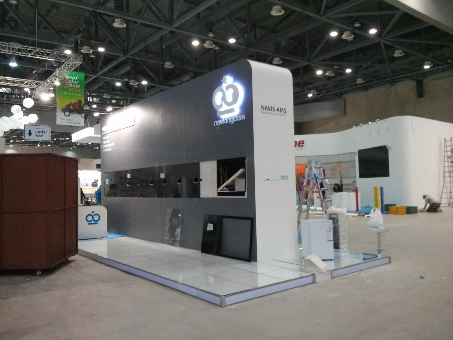 NAVIS-AMS exhibition stand during installation, showing the scale of the display